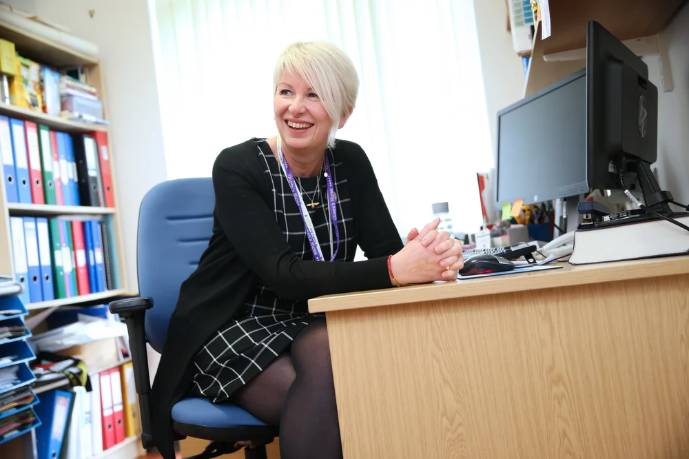 Churchill Fellow Karen Leach sat at a desk in an office