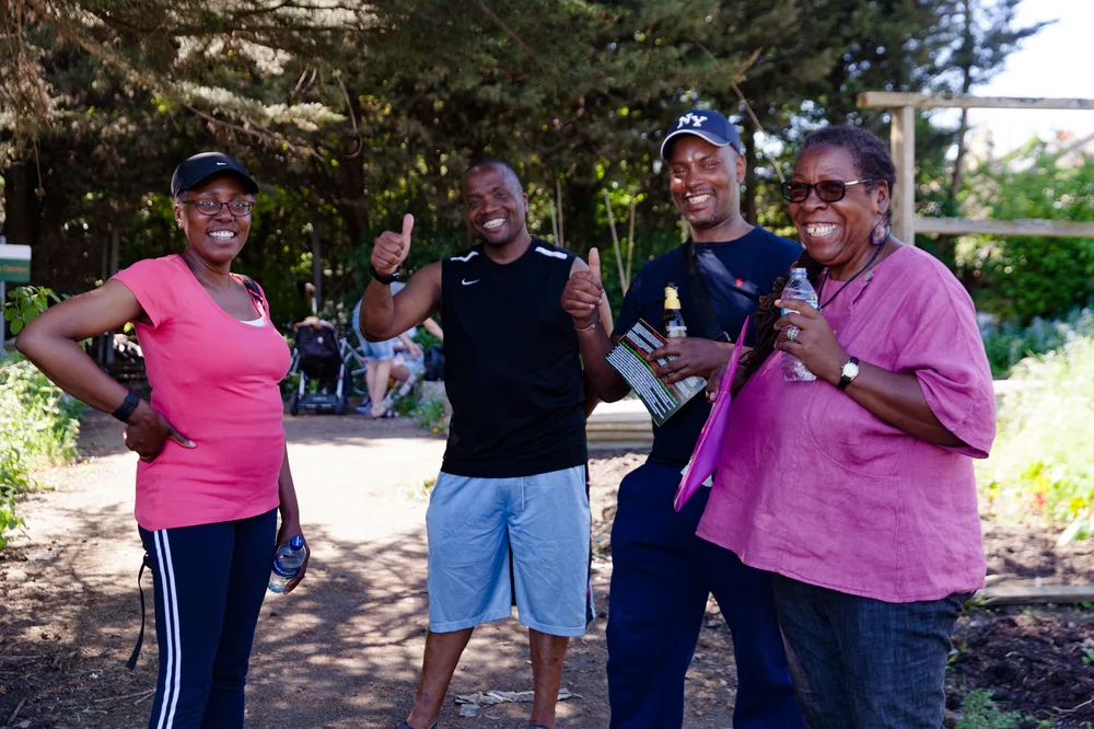 Yvonne Field with three of her programme beneficiaries outside in woodland area
